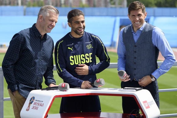 Switzerland&#039;s defender Ricardo Rodriguez, center, speaks during a SRF TV interview next to Swiss TV journalists Rainer Maria Salzgeber, left, and Former Swiss soccer player and SRF TV consultant  ...