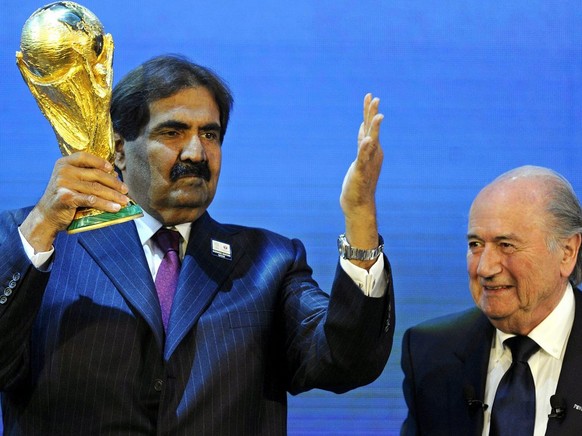 epa04011942 (FILE) A file picture dated 02 December 2010 shows FIFA President Joseph S. Blatter (R) and Sheikh Hamad bin Khalifa Al-Thani (L), Emir of Qatar, with the World Cup trophy after Qatar was  ...