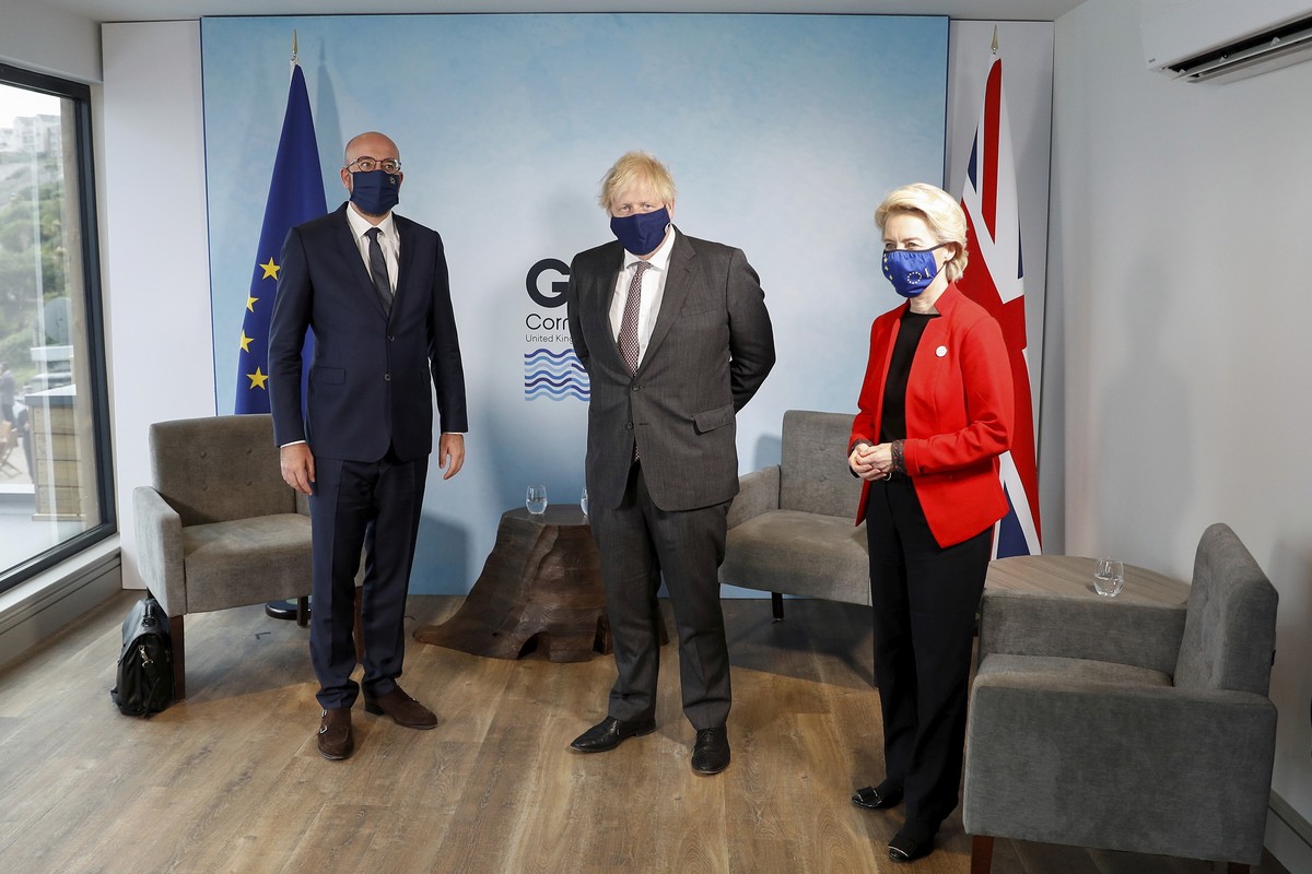 Britain's Prime Minister Boris Johnson, center, meets with European Commission President Ursula von der Leyen and European Council President Charles Michel, left, during the G7 summit in Cornwall ...