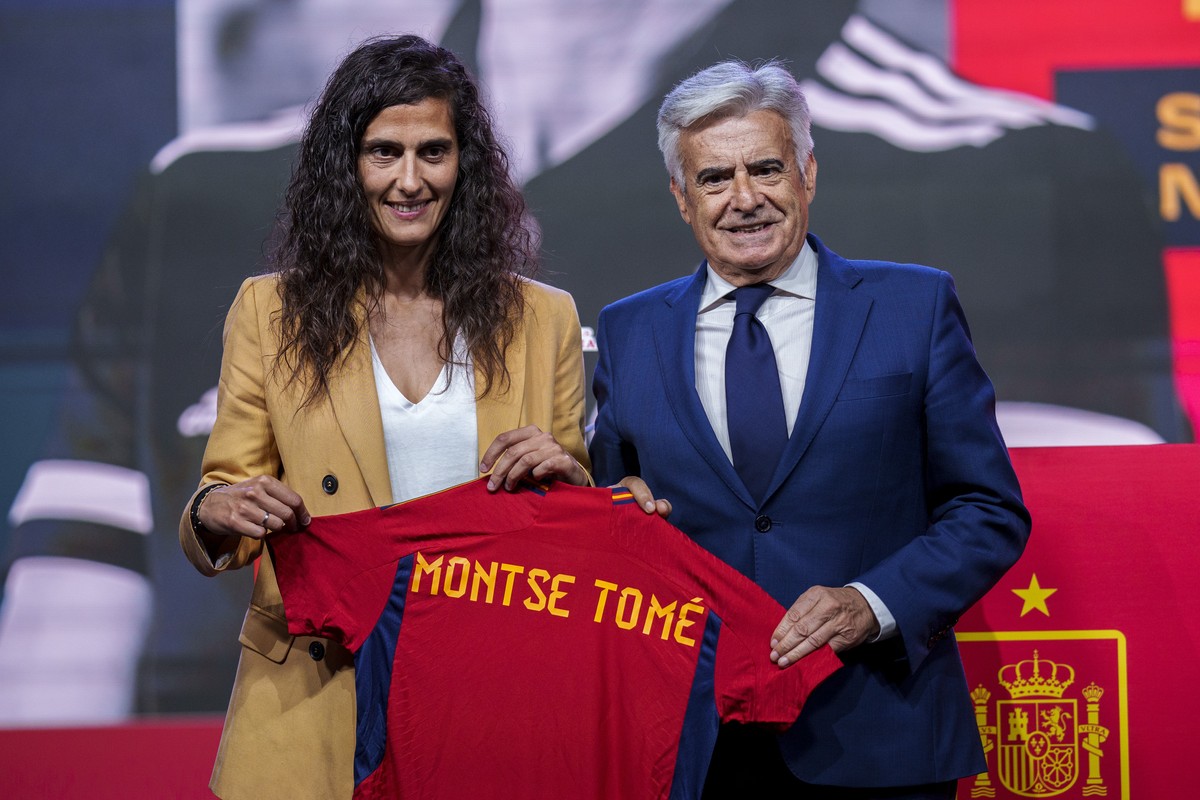 Spain's new women's national team coach Montse Tome, left, and Spanish football federation acting president Pedro Rocha hold a jersey during Tome's official presentation at the Spanish  ...