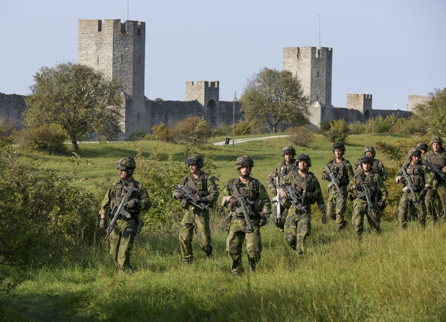 epa05824527 (FILE) - A file photograph showing soldiers from the Swedish Army&#039;s Skaraborg Armoured Regiment patroling outside Visby&#039;s 13th century city wall during a military maneuver in Vis ...