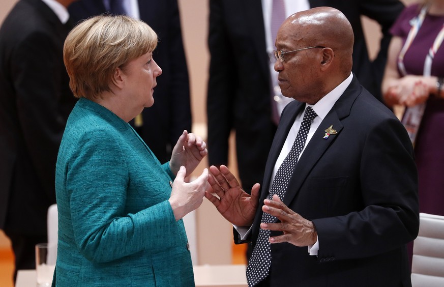 epa06075139 German Chancellor Angela Merkel (L) talks with the President of South Africa, Jacob Zuma (R), prior to a plenary session on the second day of the G20 summit in Hamburg, Germany, 08 July 20 ...
