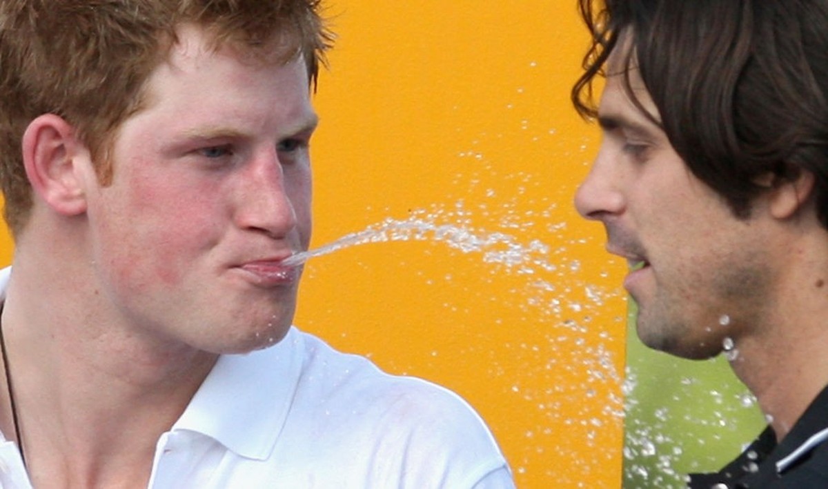 NEW YORK - MAY 30: Prince Harry (L) spits champagne at Nacho Figueras, captain of the Blackwatch team the Prince's Sentebale team triumphed in the 2009 Verve Clicquot Manhattan Polo Classic on Ma ...