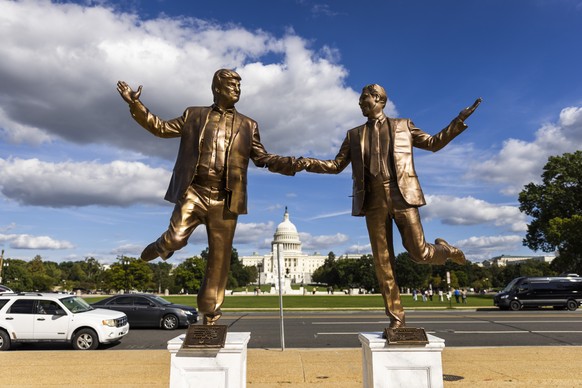 epa12425983 A statue depicting US President Donald Trump (L) holding hands with disgraced financier and child sex offender Jeffrey Epstein (R) returns to the National Mall in Washington, DC, USA, 02 O ...