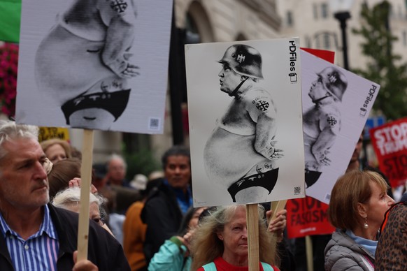 epa12385042 Protesters hold up placards with a depiction of Donald Trump on them as they march during a &#039;Stop Trump Coalition&#039; mass demonstration against the state visit to the UK by US Pres ...