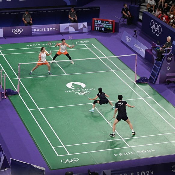 epa11513604 Tang Chun Man and Tse Ying Suet of Hong Kong (top) in action against Seung Jae Seo and Yu Jung Cha of South Korea during the Mixed Doubles quarterfinal match of the Badminton competitions  ...