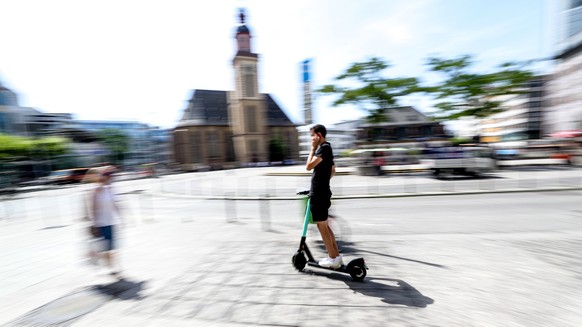 epa07672486 A man uses a e-scooter in downtown Frankfurt Main, Germany, 25 June 2019. &#039;Tier Mobility&#039; company starts the business of renting e-scooters since last weekend. The company is alr ...