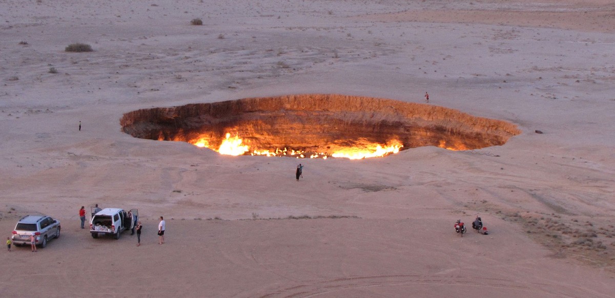 A picture taken on May 3, 2014, shows people visiting "The Gateway to Hell," a huge burning gas crater in the heart of Turkmenistan's Karakum desert.