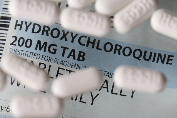 FILE - This Monday, April 6, 2020 file photo shows an arrangement of hydroxychloroquine tablets in Las Vegas. According to results released on Thursday, May 7, 2020, a new study finds no evidence of b ...