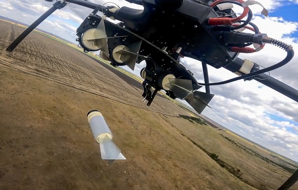 epa11622649 A still image taken from a handout video made available by the Russian Defence Ministry Press-Service on 24 September 2024 shows a Russian hexacopters drone dropping an explosive at an und ...