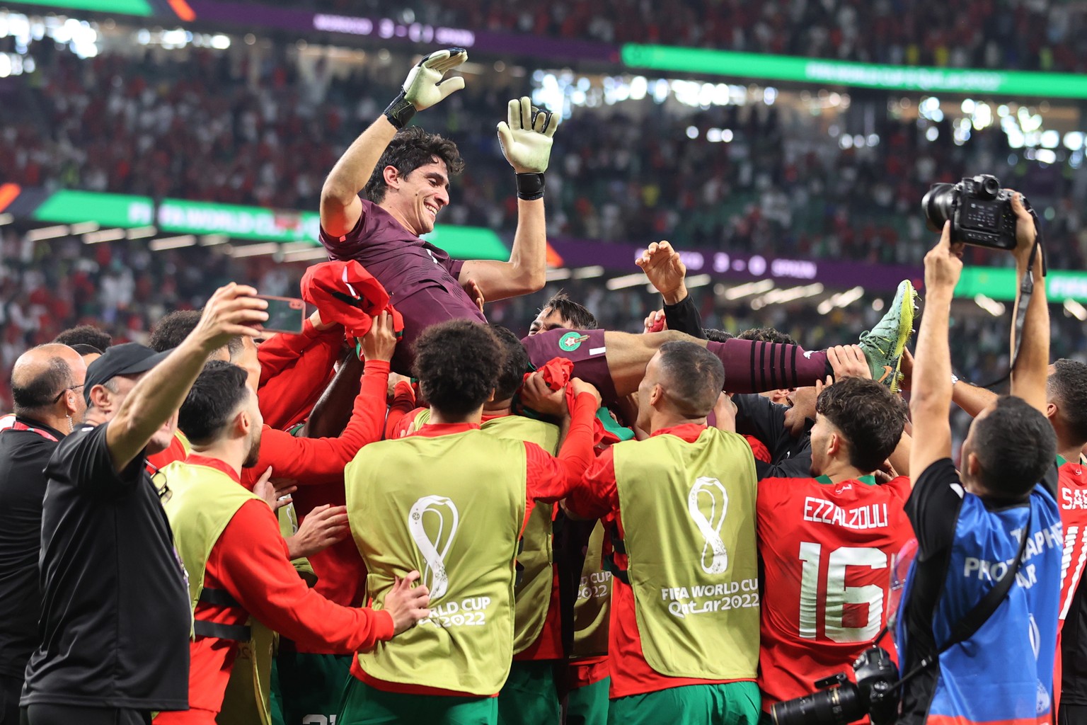 epa10352437 Players of Morocco cheer their goalkeeper Yassine Bounou for his penalty kick saves after the FIFA World Cup 2022 round of 16 soccer match between Morocco and Spain at Education City Stadi ...