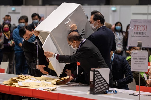 epaselect epa09650183 Election officials open ballot boxes to count votes for the Legislative Council general election at the Convention and Exhibition Centre in Hong Kong, China, 19 December 2021. Af ...