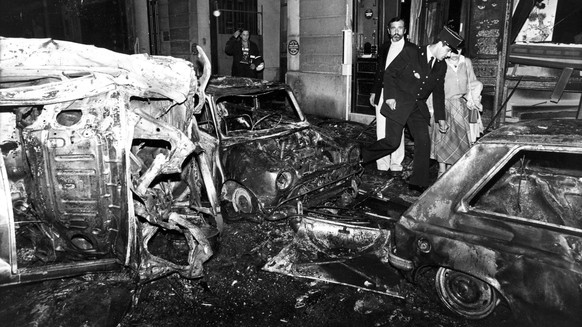 FILE - Destroyed vehicles and damabe on the building are seen at the scene after the bombing of the Copernic street synagogue in Paris, Oct. 3, 1980. A Paris court on Friday, April 21, 2023, convicted ...