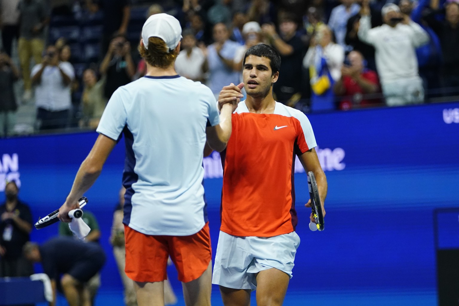 Carlos Alcaraz, of Spain, right, shakes hands with Jannik Sinner, of Italy, after Alcaraz won their match in the quarterfinals of the U.S. Open tennis championships, early Thursday, Sept. 8, 2022, in  ...