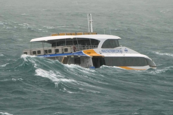 The Manly Ferry makes its way through heavy swells across Sydney Harbour, Australia, Sunday, July 3, 2022. A severe weather warning for heavy rainfall and strong winds has been issued for Sydney, as p ...
