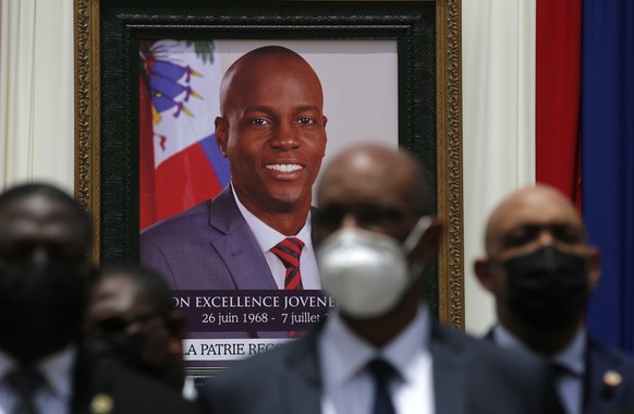 FILE - In this July 20, 2021 file photo, authorities pose for a group photo in front of the portrait of late Haitian President Jovenel Moise at at the National Pantheon Museum during his memorial serv ...