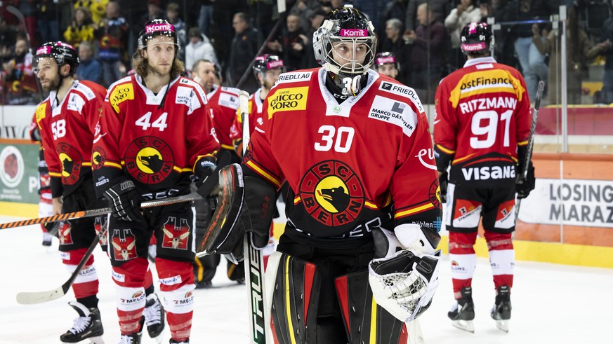 Bern goalkeeper Philipp Wuethrich and his teammate react after the 4-3 defeat, in the sixth National League ice hockey quarterfinal match between SC Bern and ACB...