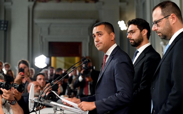 epa07786122 Movimento 5 Stelle leader Luigi Di Maio (L) with party colleagues Stefano Patuanelli (R) and Francesco D&#039;Uva (C) address the media after a meeting with Italian President Sergio Mattar ...