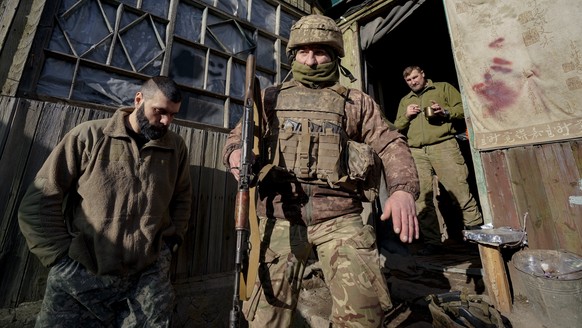 A Ukrainian serviceman leaves a coomand post to start his shift at a frontline position outside Popasna, in the Luhansk region, eastern Ukraine, Sunday, Feb. 20, 2022. Russia extended military drills  ...