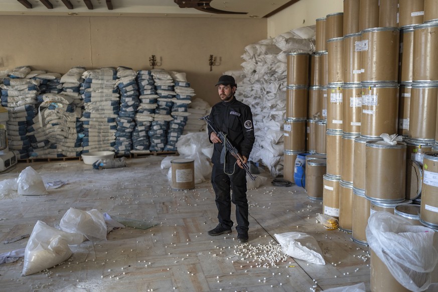 Members of the Syrian security forces inspect a lab where amphetamine pills, known as Captagon, were manufactured before the fall of Bashar Assad government outskirts of Damascus, Syria, Tuesday, Jan. ...