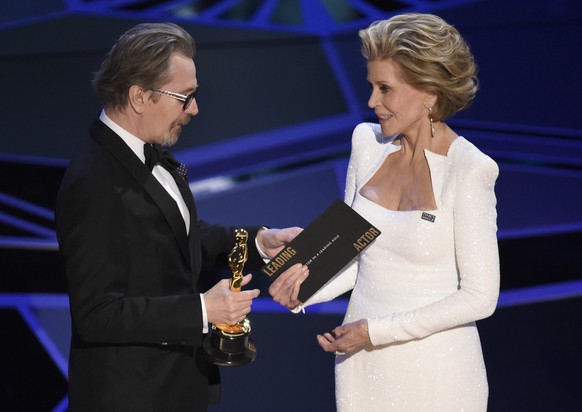 Jane Fonda, right, presents Gary Oldman with the award for best performance by an actor in a leading role for &quot;Darkest Hour&quot; at the Oscars on Sunday, March 4, 2018, at the Dolby Theatre in L ...