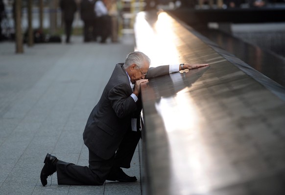 epa05532922 (FILE) A file picture dated 11 September 2011 shows Robert Peraza, who lost his son Robert David Peraza, pauses at his son&#039;s name at the North Pool of the 9/11 Memorial during tenth a ...