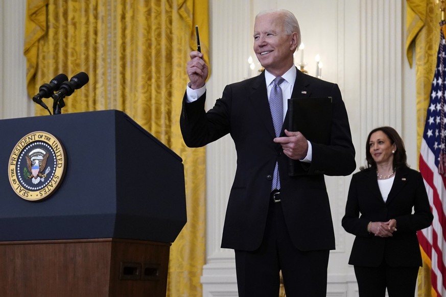 Vice President Kamala Harris watches as President Joe Biden takes a question from a reporter after speaking about distribution of COVID-19 vaccines, in the East Room of the White House, Monday, May 17 ...