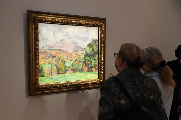 epa10277354 People view &#039;La Montagne Sainte-Victoire&#039; by French artist Paul Cezanne, estimated in excess of 120 million USD, during a preview of the sale &#039;Visionary: The Collection of P ...