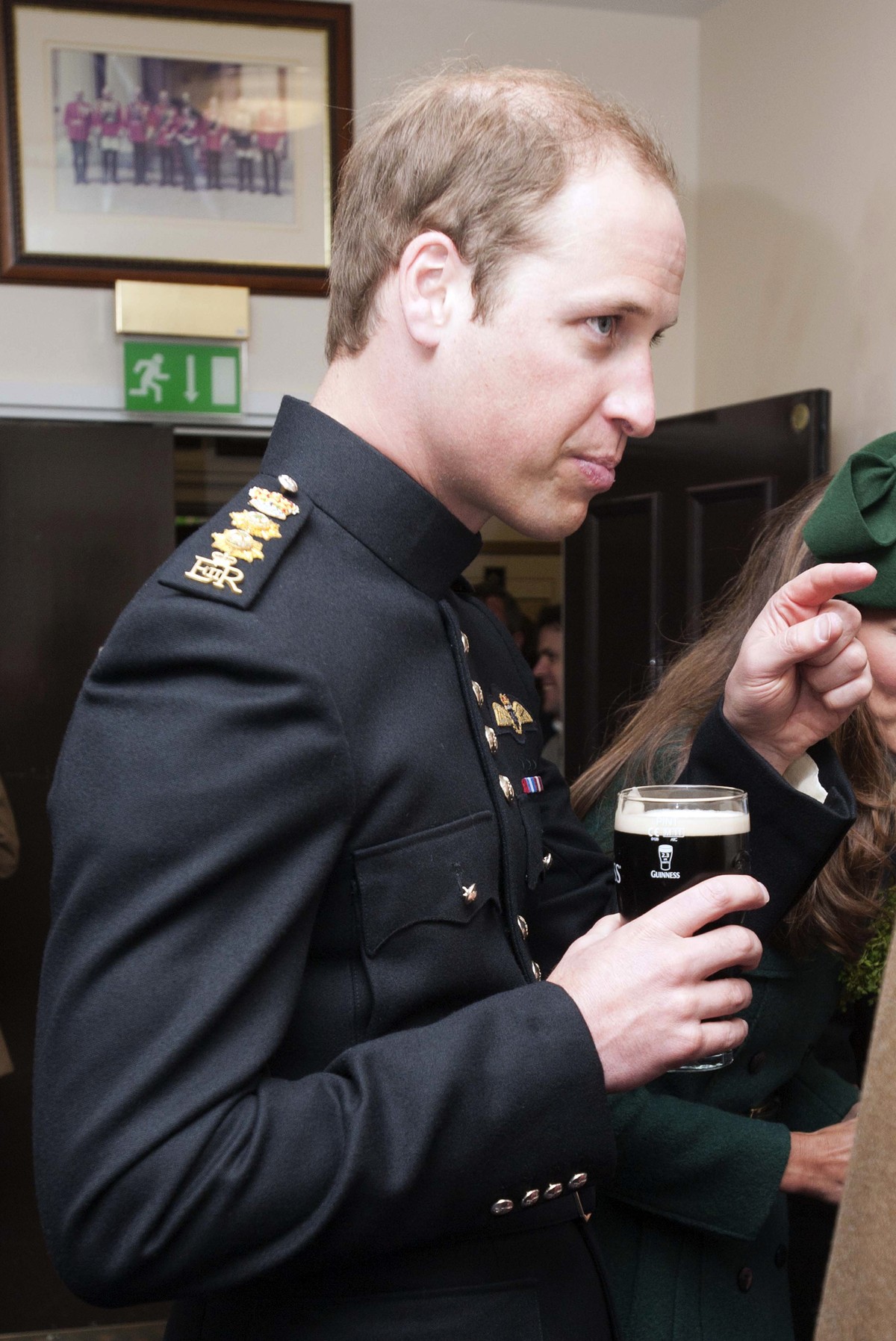 Prince William holds a pint of Guinness during a visit to the 1st Battalion Irish Guards at the St. Patrick's Day Parade at Mons Barracks, Aldershot, in England, Monday, March 17, 2014. The Duke  ...