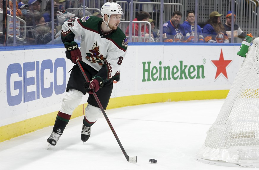 Arizona Coyotes defenseman Janis Moser (62) skates around the goal during the second period of the team's NHL hockey game against the New York Islanders, Friday, Jan. 21, 2022, in Elmont, N.Y. (AP Pho ...