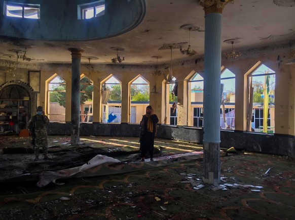 epa09513412 Taliban inspect the scene of a bomb blast that targeted a Shi&#039;ite Muslims mosque in Kunduz, Afghanistan, 08 October 2021. Several people feared dead during Friday congregational praye ...