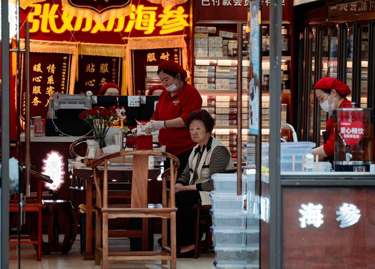 epa12947267 A customer sits in a grocery shop in Shanghai, China, 11 May 2026. The National Bureau of Statistics of China reported that annual inflation rose to 1.2 percent in April 2026, up from 1.0  ...