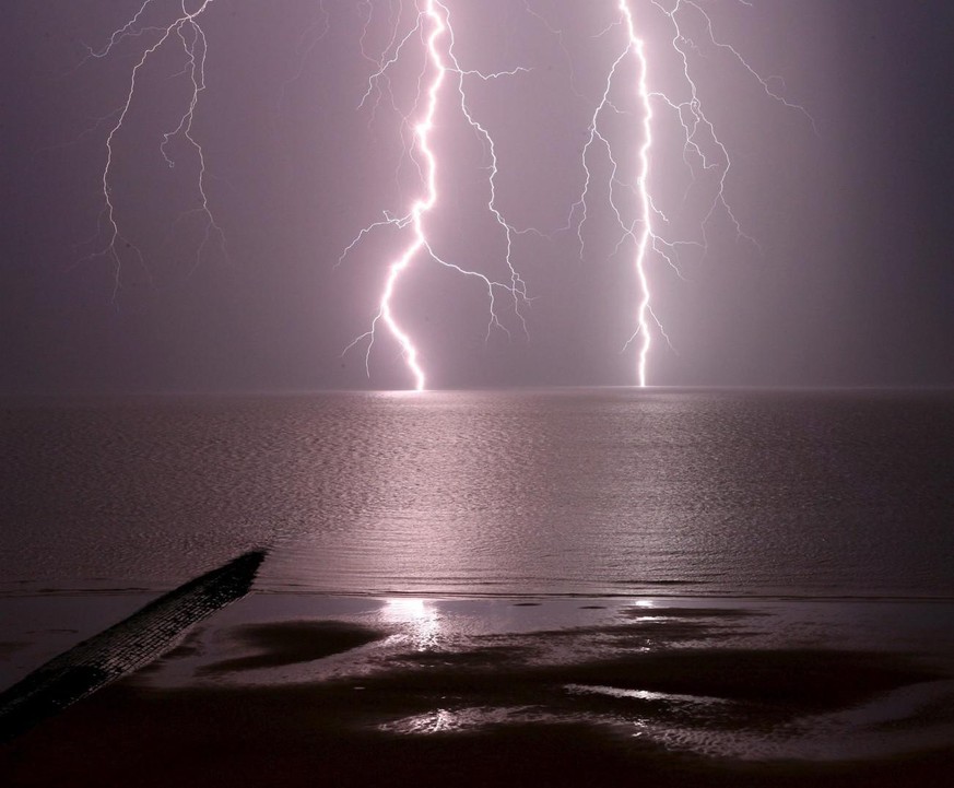 A thunder storm and lightning passes the coast of the Belgian North Sea off Middelkerke, West Flanders province, Wednesday 05 July 2006. EPA/OLIVIER MATTHYS