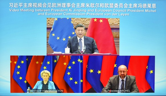 In this photo released by China&#039;s Xinhua News Agency, Chinese President Xi Jinping, top, speaks during a video meeting with European Commission President Ursula von der Leyen, lower left, and Eur ...