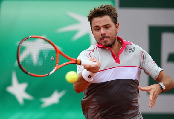 PARIS, FRANCE - MAY 24: Stanislas Wawrinka of Switzerland plays a forehand in his Men&#039;s Singles match against Marsel Ilhan of Turkey on day one of the 2015 French Open at Roland Garros on May 24, ...