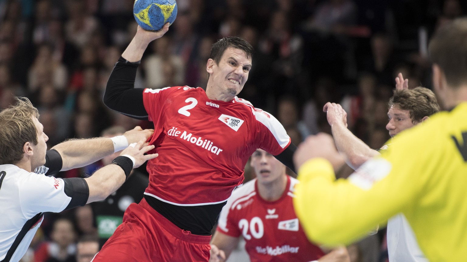 Swiss Andy Schmid, center, in action against Germany&#039;s Uwe Gensheimer, right, during the Handball EHF Euro 2018 qualification game between Switzerland and Germany in Zurich, Switzerland, Saturday ...