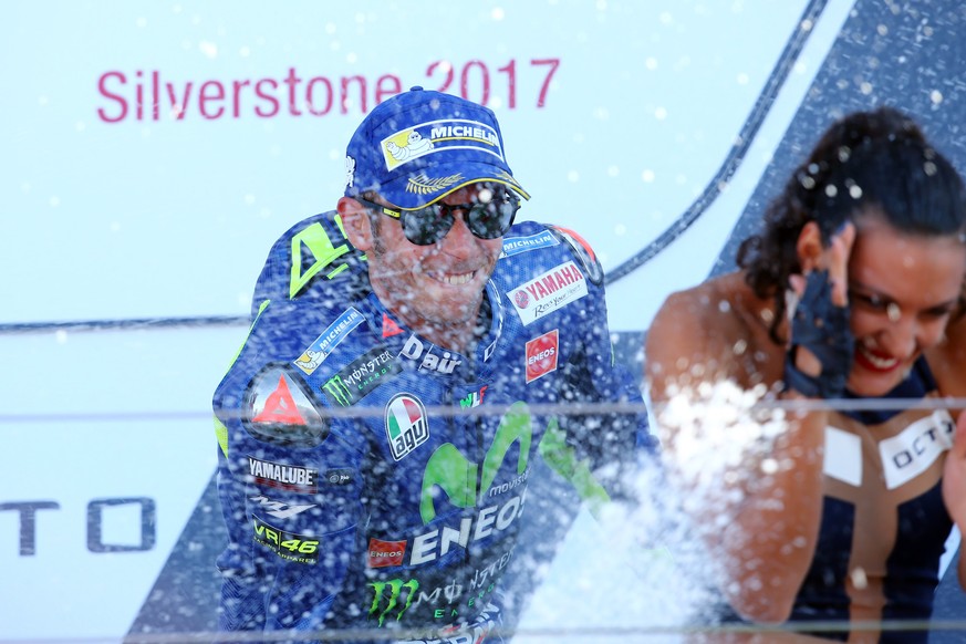 epa06166914 Italian Moto GP rider Valentino Rossi of the Movistar Yamaha MotoGP team celebrates his 3rd place on the podium during the MotoGP race of the 2017 British Motorcycling Grand Prix at the Si ...