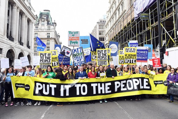 epa07458070 Protester carry a banner &#039;Put it to the People&#039; as people attend the &#039;Put it to the People&#039; march in London, Britain, 23 March 2019. Hundreds of thousands of people tak ...