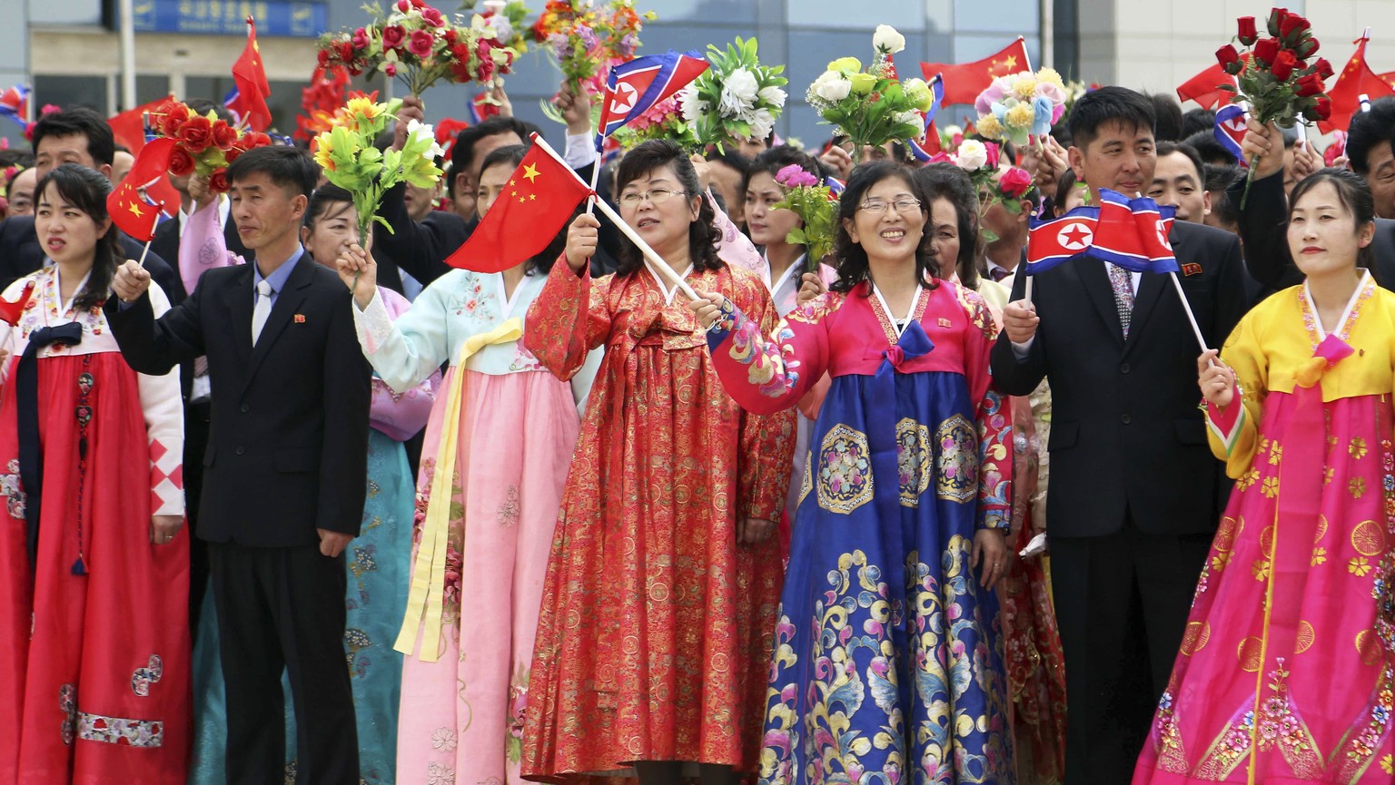 Pyongyang citizens welcome a Chinese delegation headed by Zhao Leji, chairman of the National People?s Congress and considered the No. 3 official in the ruling Communist Party, as they arrive at the P ...