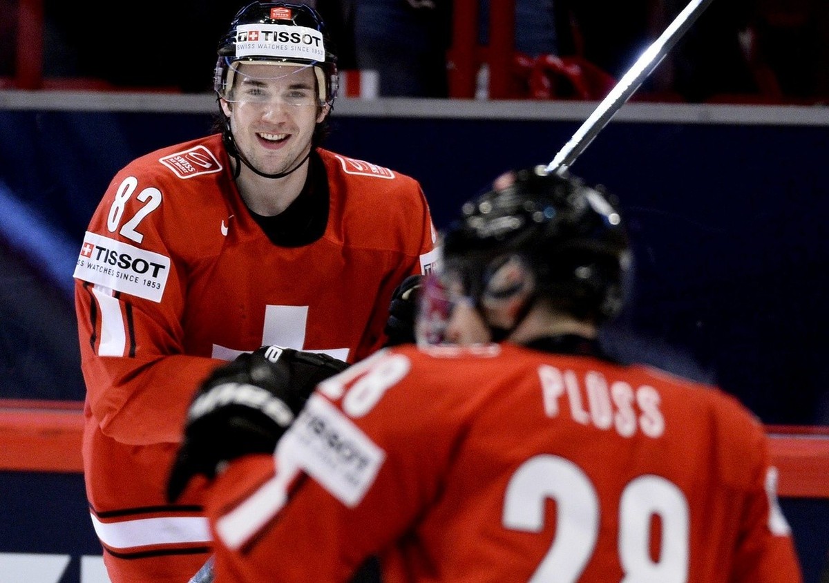 Switzerland's Simon Moser, top, reacts after the 5-1 goal against Slovenia during the Ice Hockey World Championship group A match in Stockholm, Sweden, Tuesday May 8, 2013. (AP Photo/Anders Wiklu ...
