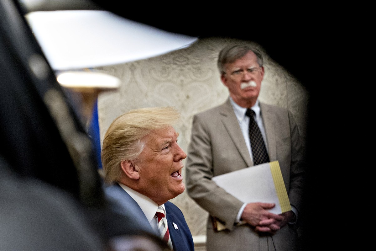 epa08493524 (FILE) - US President Donald Trump speaks as John Bolton, national security advisor, listens during his meeting with Klaus Iohannis, Romania's president, not pictured, in the Oval Off ...