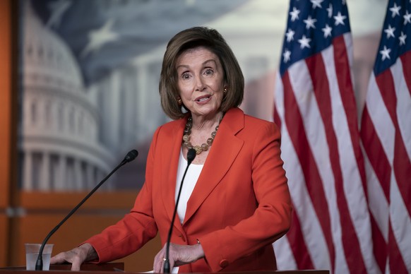 Speaker of the House Nancy Pelosi, D-Calif., talks to reporters just before the House vote on a resolution to formalize the impeachment investigation of President Donald Trump, in Washington, Thursday ...