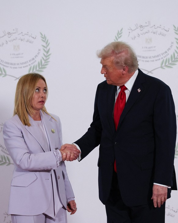 U.S. President Donald Trump and Italian Prime Minister Giorgia Meloni shake hands as they pose for a photo, at a world leaders&#039; summit on ending the Gaza war, amid a U.S.-brokered prisoner-hostag ...