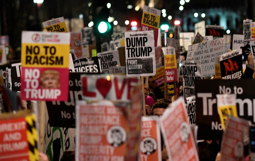 Demonstrators hold placards during a protest against U.S. President Donald Trump&#039;s executive order travel ban in London, Britain January 30, 2017. REUTERS/Dylan Martinez