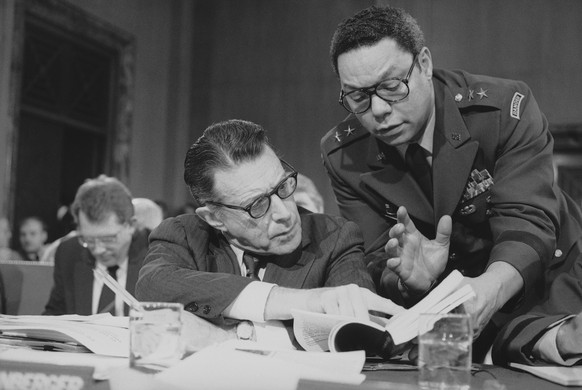 FILE - In this Feb. 8, 1985 file photo, U.S. Defense Secretary Casper Weinberger confers with Army Maj. Gen. Colin Powell during testimony before the Senate Budget Committee on Capitol Hill in Washing ...