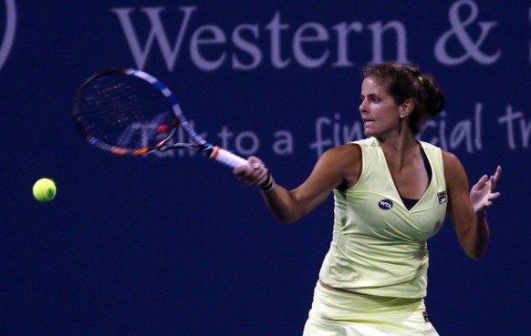 Julia Görges, of Germany, returns the ball to Andrea Petkovic, of Germany, at the Western &amp; Southern Open tennis tournament, Monday Aug. 17, 2015, in Mason, Ohio. (AP Photo/Tom Uhlman)