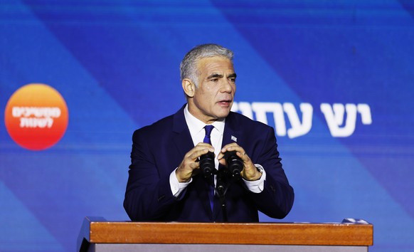 epa10280518 Israeli Prime Minister Yair Lapid reacts to the preliminary election results with his supporters at his campaign headquarters in Tel Aviv, Israel, 01 November 2022. Israelis headed to the  ...