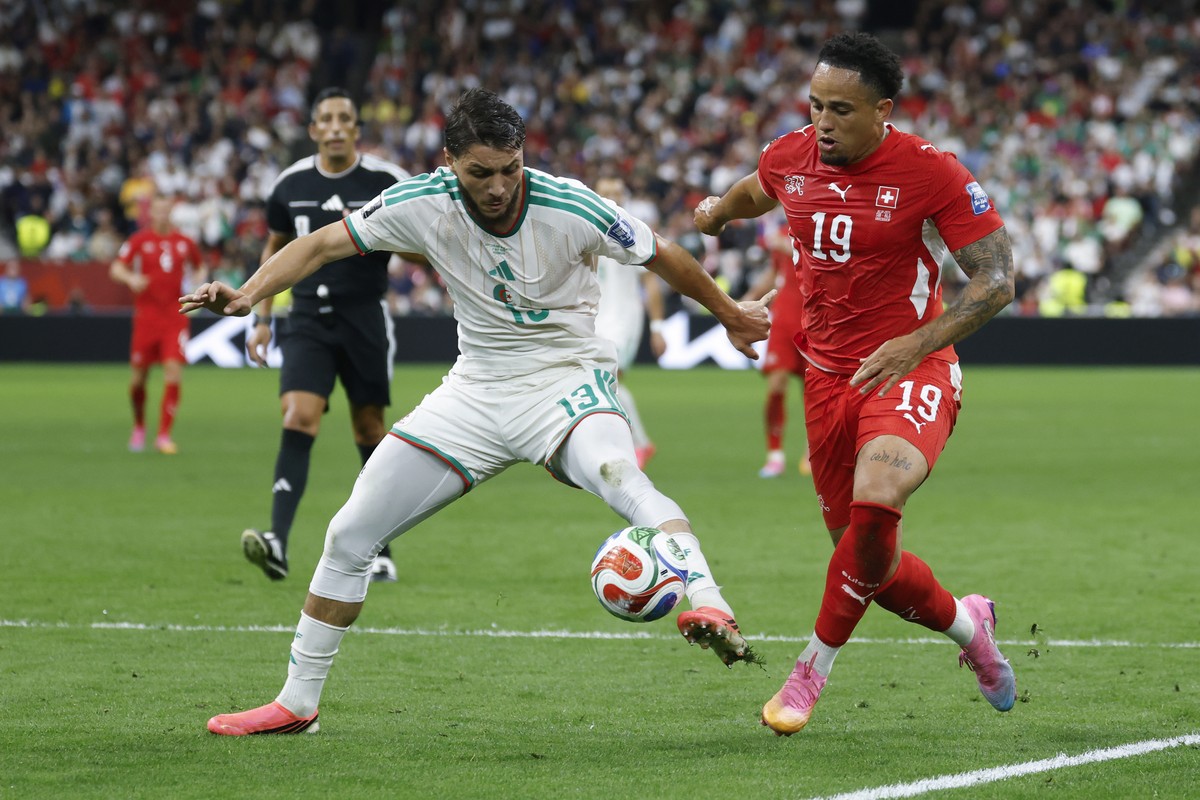 Algeria's Jaouen Hadjam, left, and Switzerland's Noah Okafor in action during the World Cup round of 32 soccer match between Switzerland and Algeria at the BC Place stadium in Vancouver, Can ...
