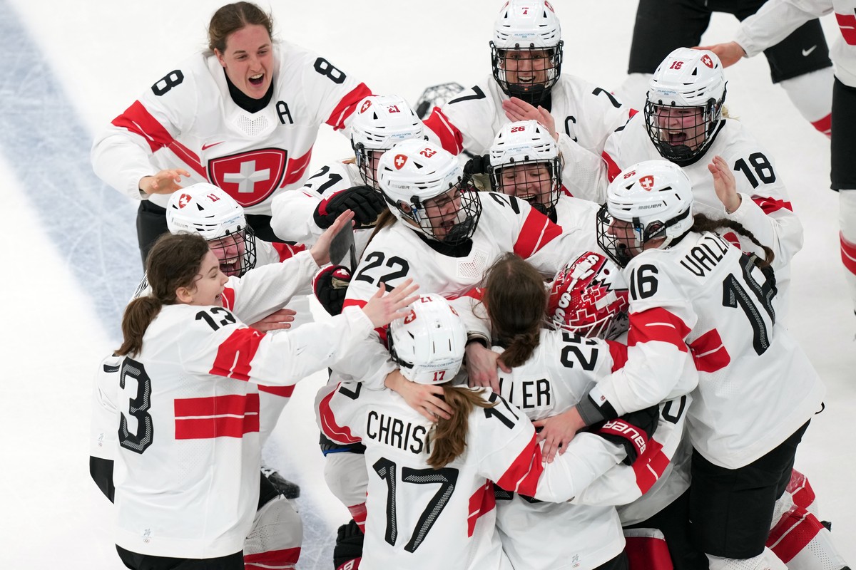 Team Switzerland players celebrate after Alina Muller (25) scored the winning goal in overtime to beat Sweden in the women's ice hockey bronze medal game at the 2026 Winter Olympics, in Milan, It ...