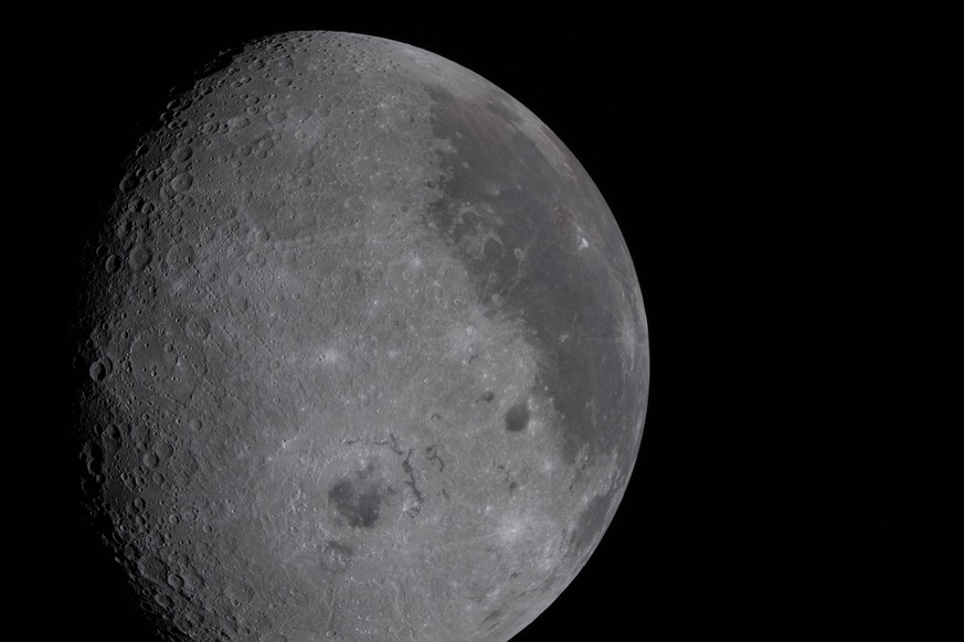 April 8, 2026, Orion Capsule, Outer Space: The Moon captured through the Orion spacecraft window, April 6, 2026, during the Artemis II flyby of the far side of the Moon. The 600-mile-wide impact crate ...